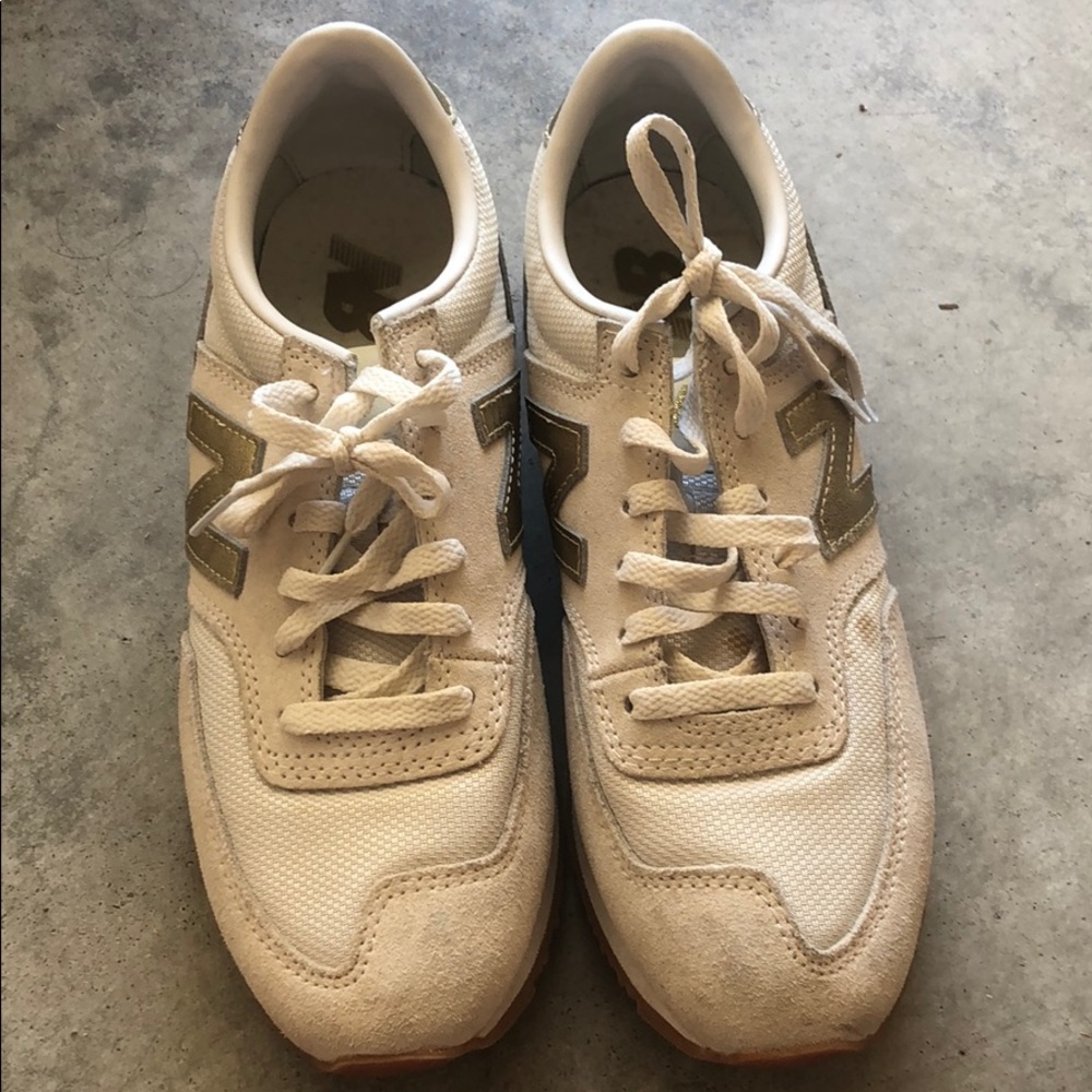 White and gold new balance shoes